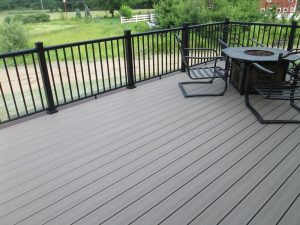 This deck has a A Trex Reveals black aluminum railing and a fire pit on the deck in Milford Square, PA