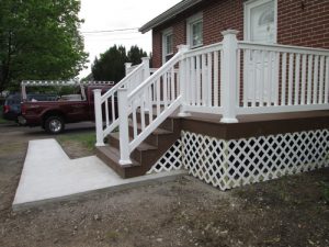 Front entrance stairs and Trex deck with white vinyl railings built on a home in Perkasie, PA.