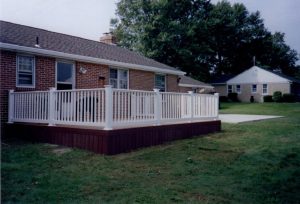 A Trex Select Madeira red deck with skirt and white vinyl railings built in Sellersville, PA.