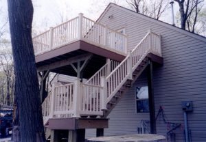 A studio deck made of Trex Select Saddle with stairs and a landing on a home in Perkasie, PA.