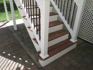 A Trex "Tiki Torch" deck with custom stairs, vinyl rails and tubular balusters built in Perkasie, PA.