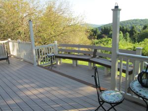 A Trex Transcends two tone deck with built-in seating, vinyl rails and custom lamp posts located in Riegelsville, PA.