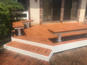 Zuri decking with stairs and built-in seating on composite deck in Perkasie, PA.