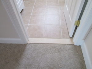 This 12" x 12" ceramic tile bathroom floor with Marble threshold was constructed in a home located in Silverdale, PA.