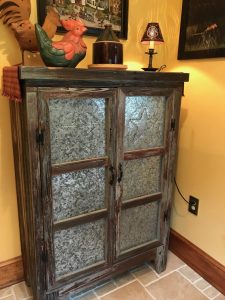 This n antique pie safe made from salvaged barn boards with punched metal design.