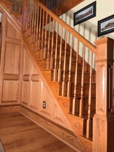 We constructed this oak staircase with 6x6 newel post turned spindles, decorative scrolled riser trim, with recessed panels in Quakertown, PA.