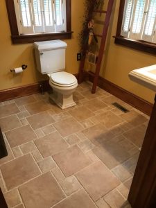Remodeled powder room with random pattern ceramic tile in Quakertown, PA.