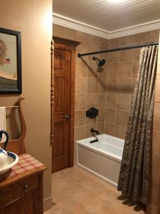 In Quakertown, PA we remodeled a bathroom with ceramic tiled wall and flooring with crown molding ceiling.