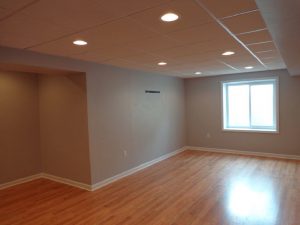 This Basement remodel with a drop ceiling with oak laminate flooring in this home in Plumsteadville, PA.