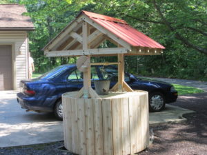 A custom cedar wishing well to hide electrical utility box for a home owner in Bedminster, PA.
