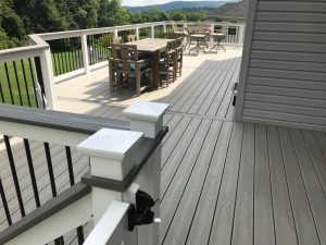 Trex Transcends deck project (Gravel Path) with vinyl railings, black tubular balusters and cocktail railing built in Center Valley, PA.