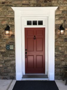 Raised panel front door with fluted trim work on a home located in Quakertown, PA.