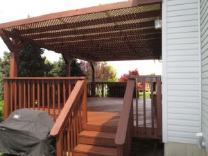 A shaded deck with a lattice roof structure built on a home in Quakertown, PA.