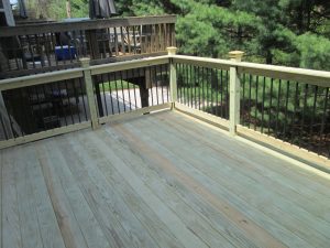 A pressure treated deck project with black tubular balusters built in Center Valley, PA.